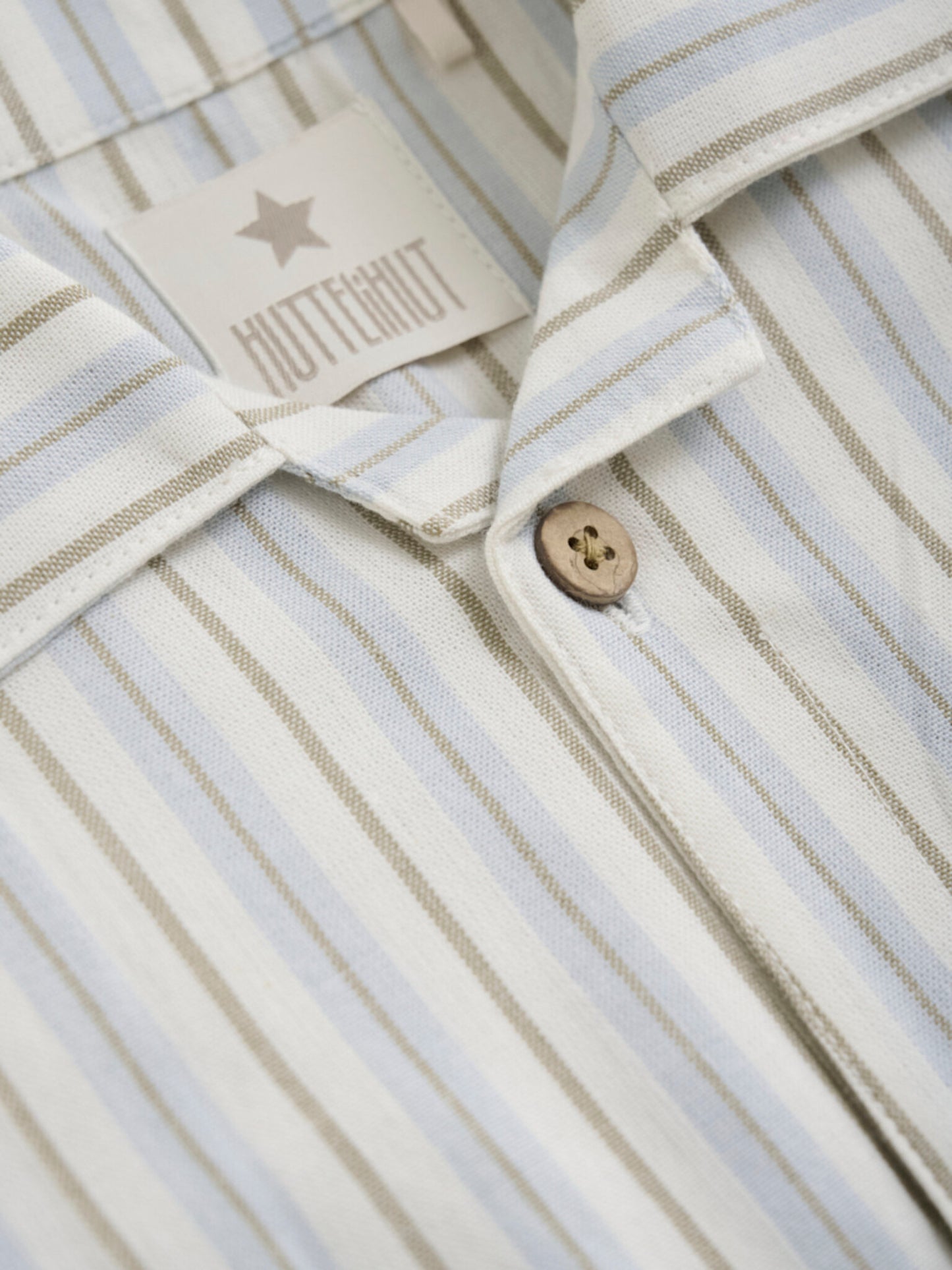 Huttelihut Button down boys shirt. Great for Polo inspired, tennis club look.Let your child make a statement in fashion while enjoying precious moments with mom. With its timeless design and impeccable quality, the Huttelihut Button Down Woven Shirt is a must-have addition to any young trendsetter's wardrobe. free shipping to Canada and the US on orders over $100, with standard shipping rates of $6 CAD / $4.30 USD for orders below. Plus, rest assured, duties into the US are included.