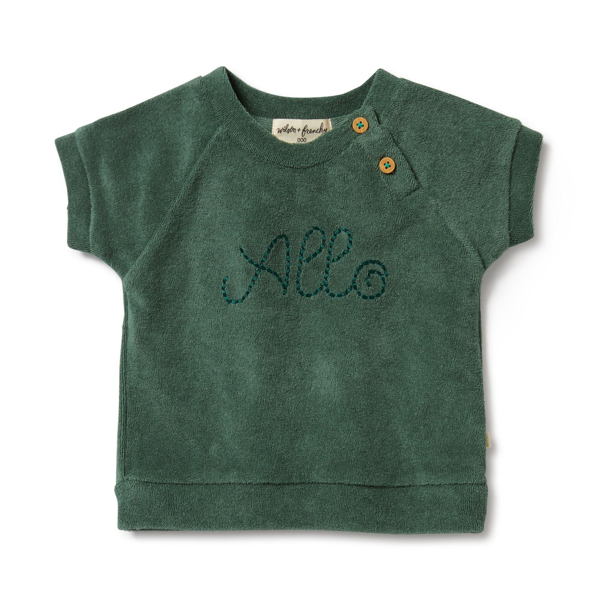 Elevate your little one's wardrobe with the adorable 'Allo' Baby Terry Cloth Green Tee from Wilson & Frenchy. Crafted with soft terry cloth fabric, this charming tee features the word "allo" embroidered on the front, adding a playful touch to any outfit. Imported from Australia, this high-quality tee is perfect for everyday wear or special occasions. Enjoy free shipping to Canada and the US on orders over $100, with standard shipping rates of $6 CAD / $4.30 USD for orders below the threshold.