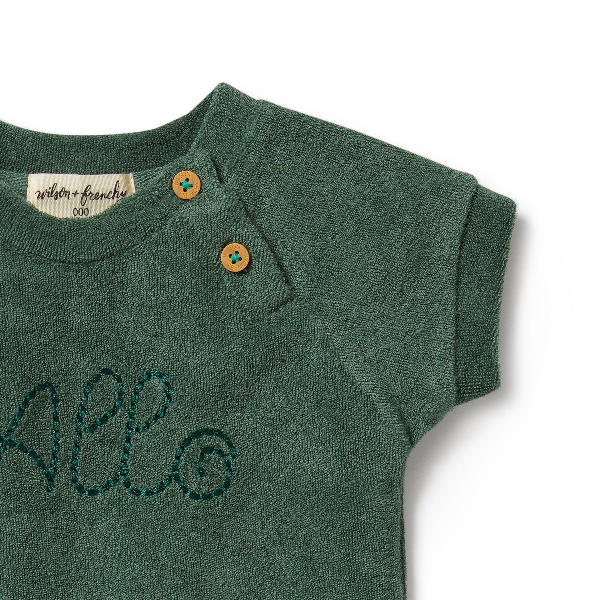 Elevate your little one's wardrobe with the adorable 'Allo' Baby Terry Cloth Green Tee from Wilson & Frenchy. Crafted with soft terry cloth fabric, this charming tee features the word "allo" embroidered on the front, adding a playful touch to any outfit. Imported from Australia, this high-quality tee is perfect for everyday wear or special occasions. Enjoy free shipping to Canada and the US on orders over $100, with standard shipping rates of $6 CAD / $4.30 USD for orders below the threshold.