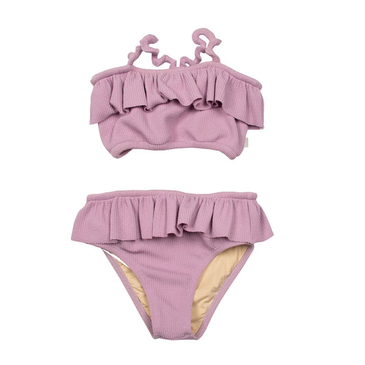 Suuky made in portugal Mauve Frilled Mauve Shell Bikini, a stylish and sustainable swimwear option for children. Crafted from a blend of 16% elastane and 84% recycled polyester. Palm Beach. Size 2y, 4y,6y. Luxury. Eco-friendly kids bathing suit. free shipping to Canada and the US on orders over $100, with standard shipping rates of $6 CAD / $4.30 USD for orders below. Plus, rest assured, duties into the US are included, making your shopping experience hassle-free